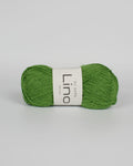 A apple green ball of linen yarn on a white background