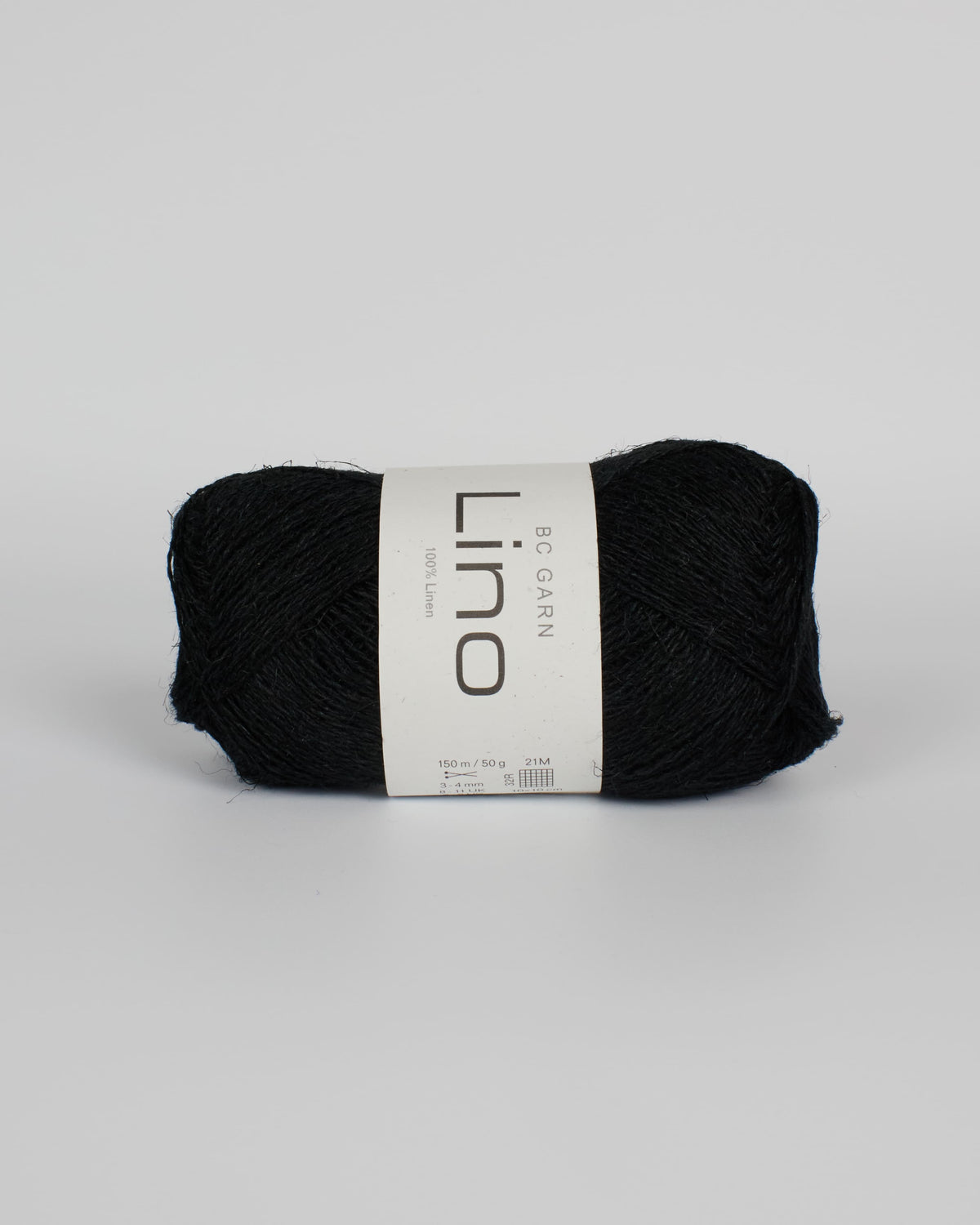 A black ball of linen yarn on a white background