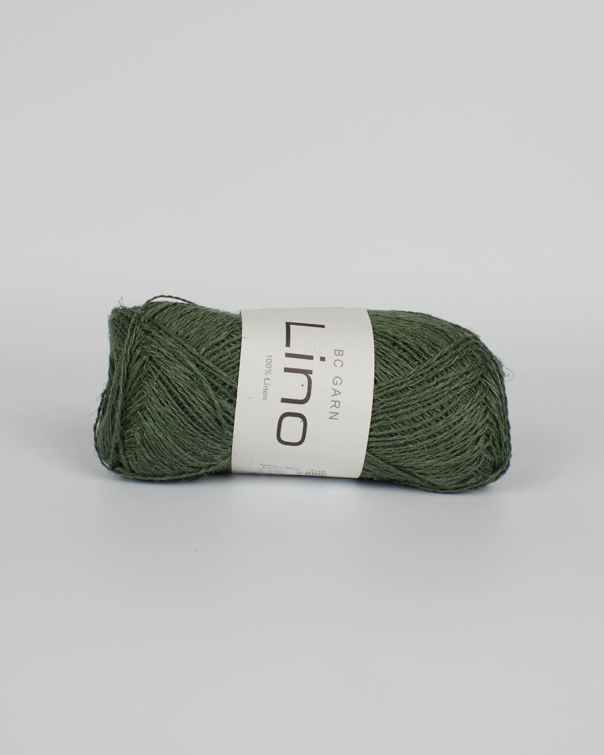 An olive green ball of linen yarn on a white background