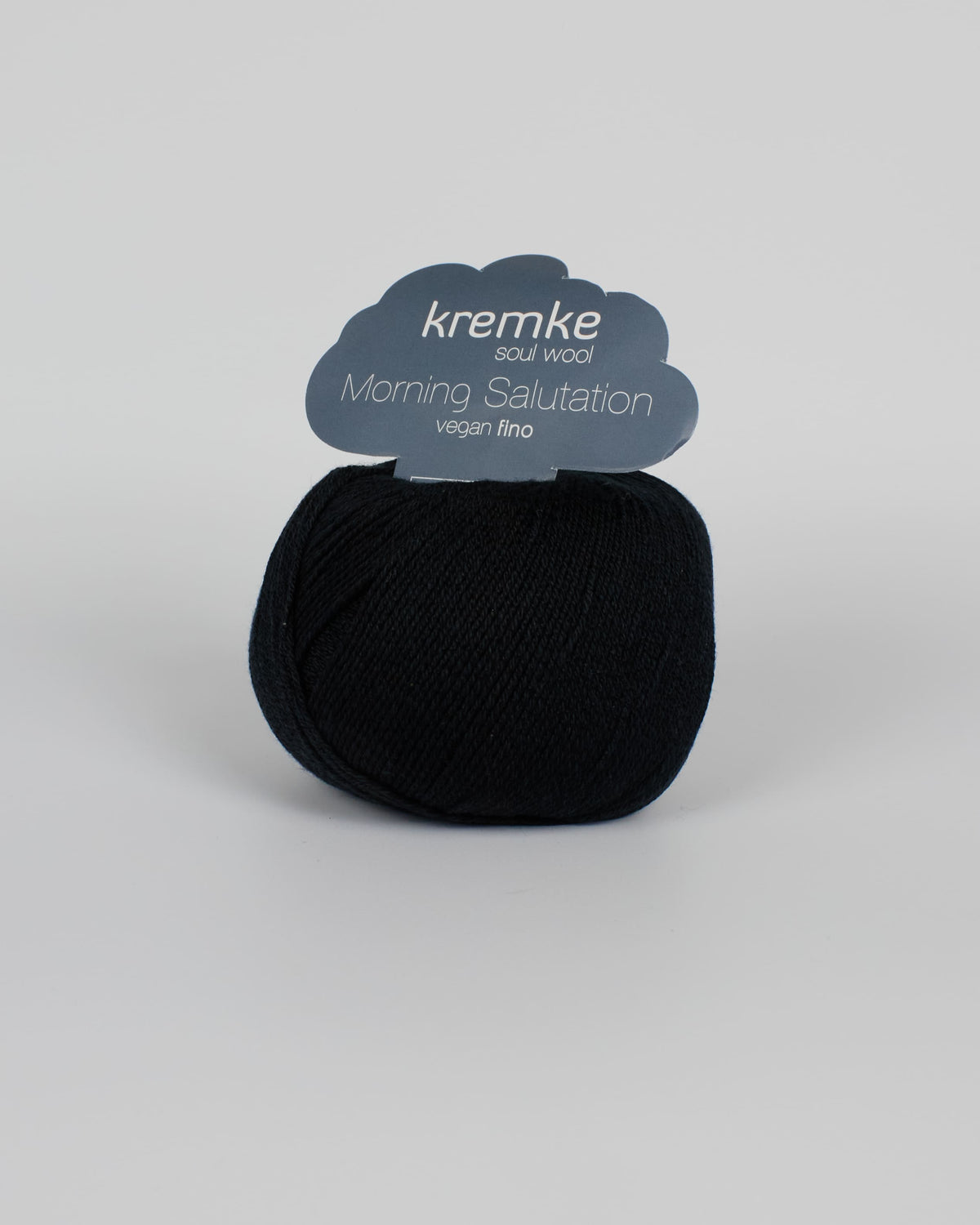 A black ball of yarn on a white background