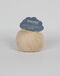 A pale beige ball of yarn on a white background