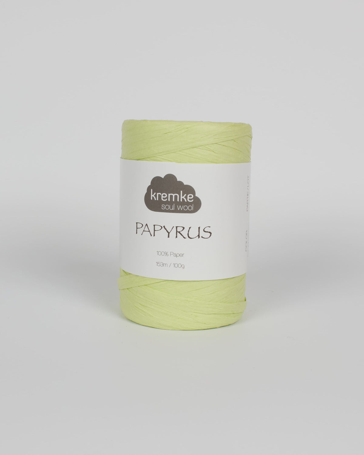 a pale yellow green ball of raffia yarn on a white background