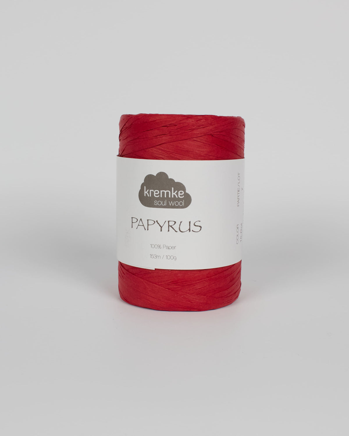 A red ball of raffia yarn on a white background