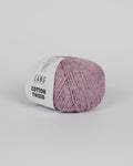 A lilac ball of yarn with multicoloured tweed flecks on a white background