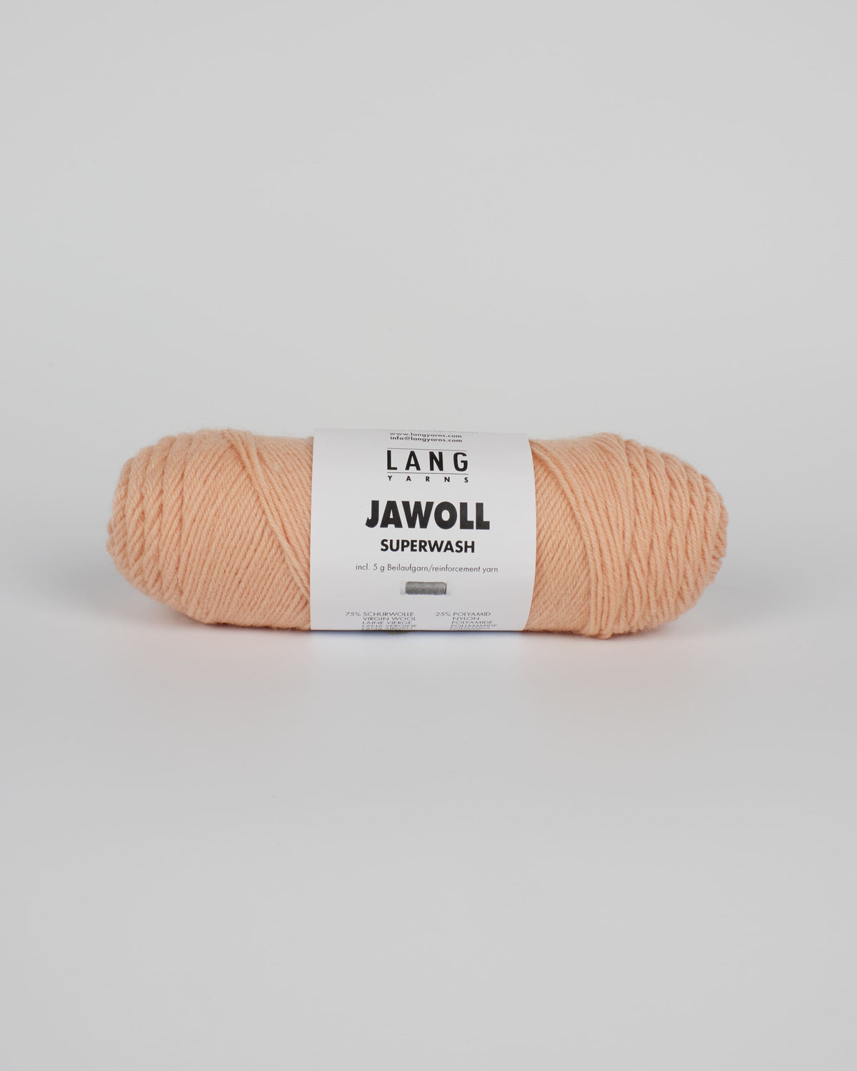 An light peach ball of yarn on a white background