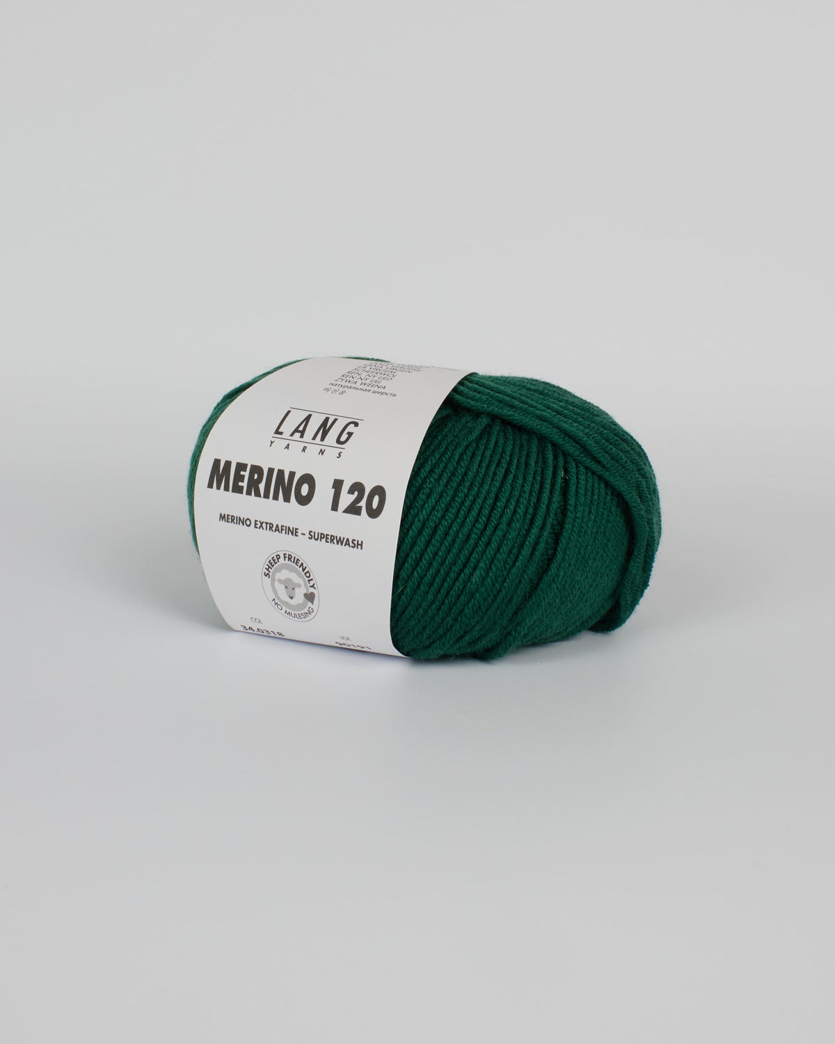 A bottle green ball of yarn on a white background