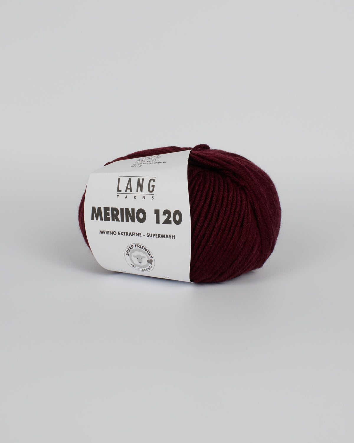 A dark burgundy ball of yarn on a white background