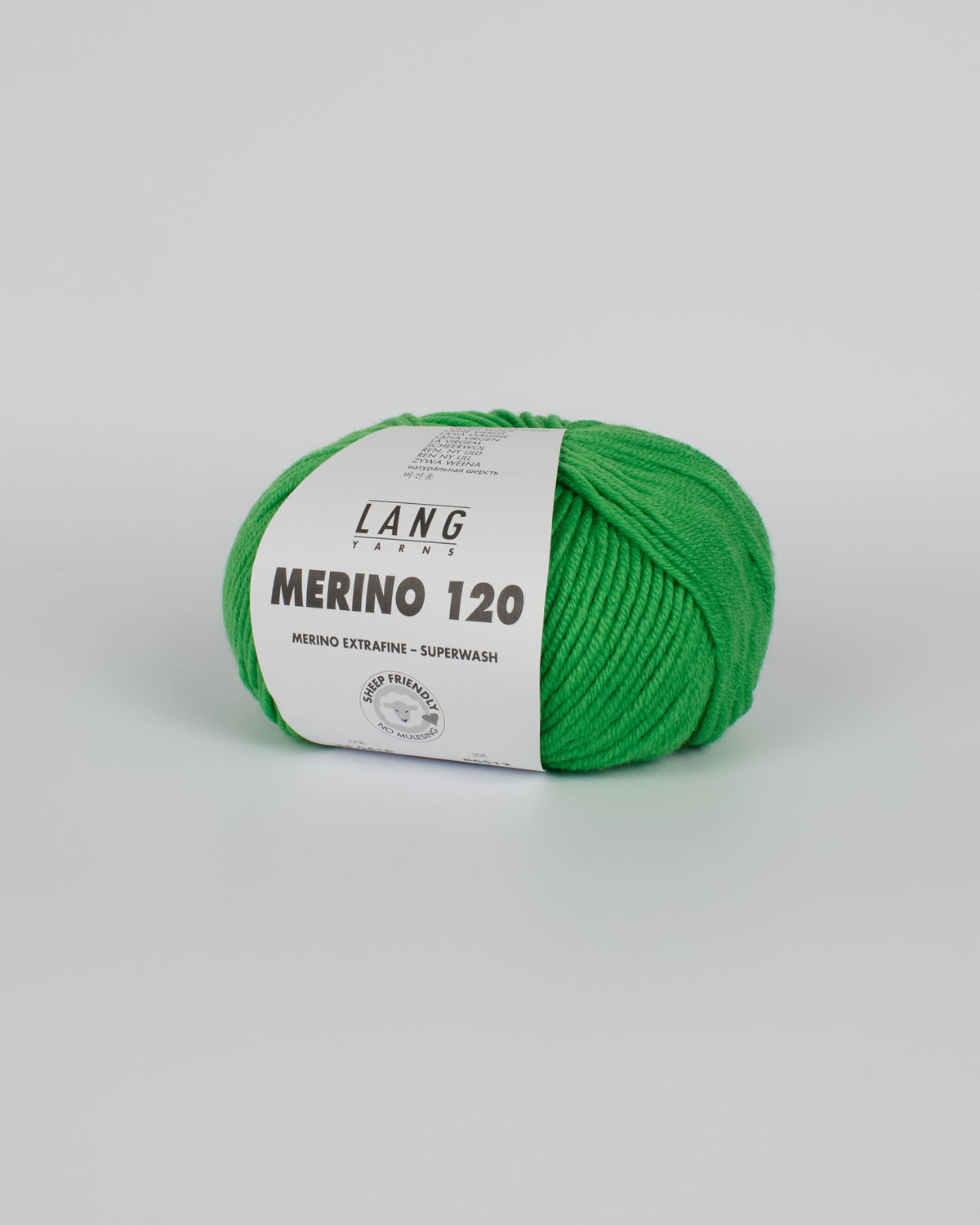 An apple green ball of yarn on a white background