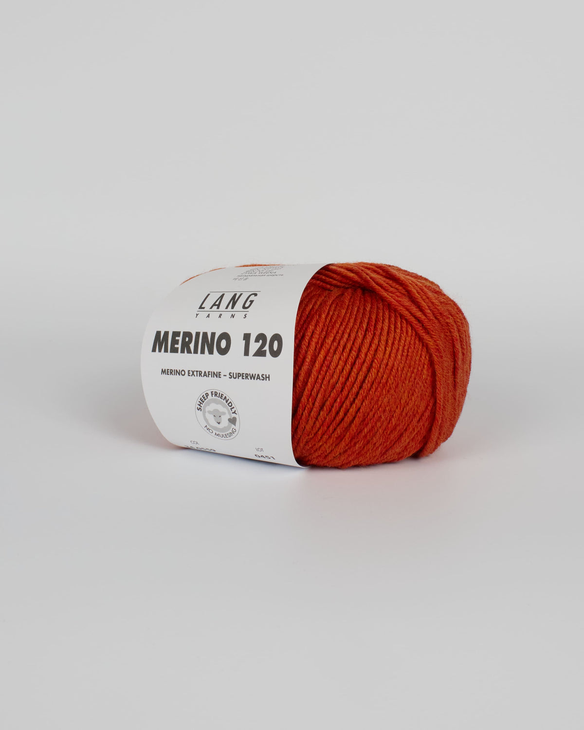 A brick red ball of yarn on a white background