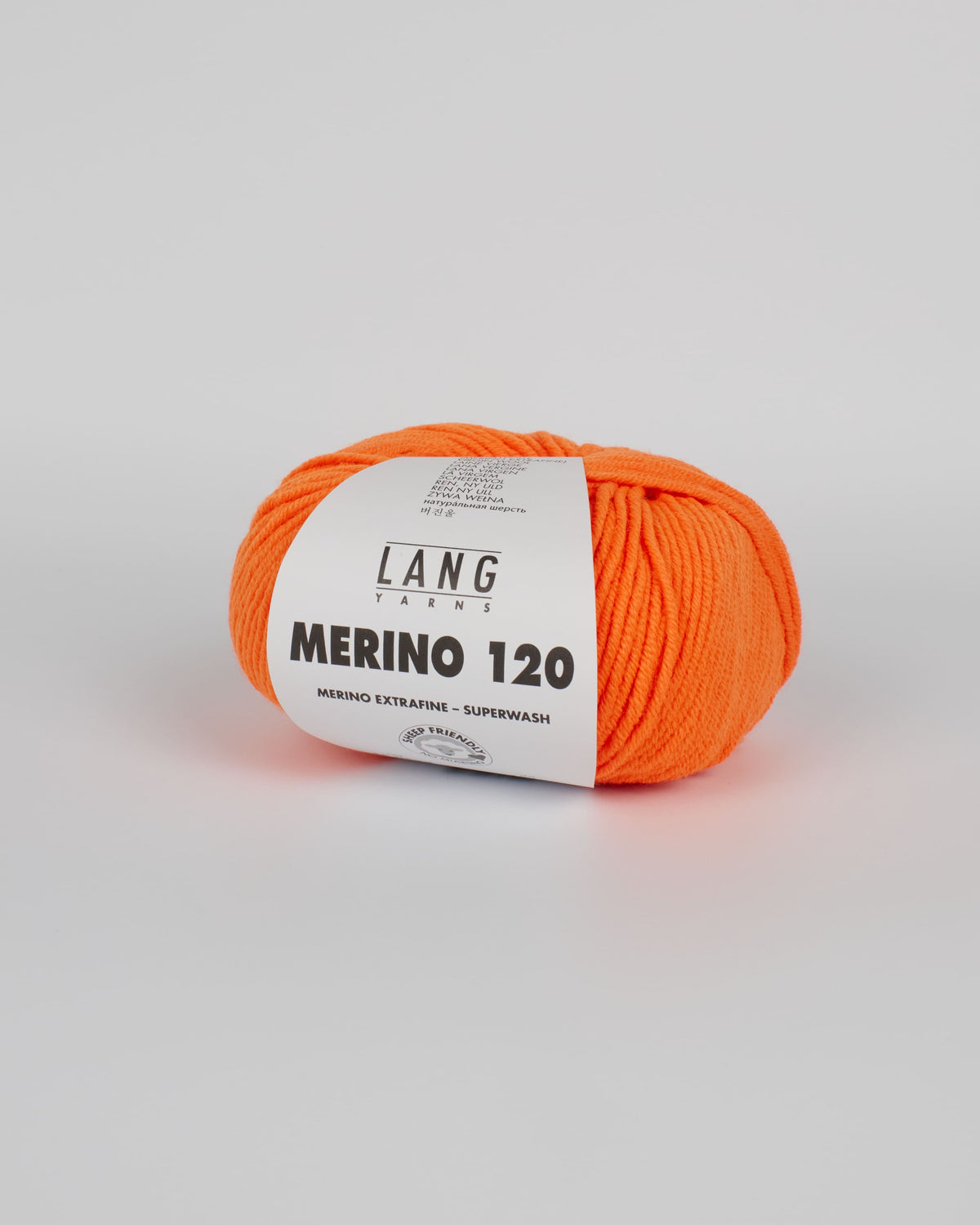 A bright orange ball of yarn on a white background