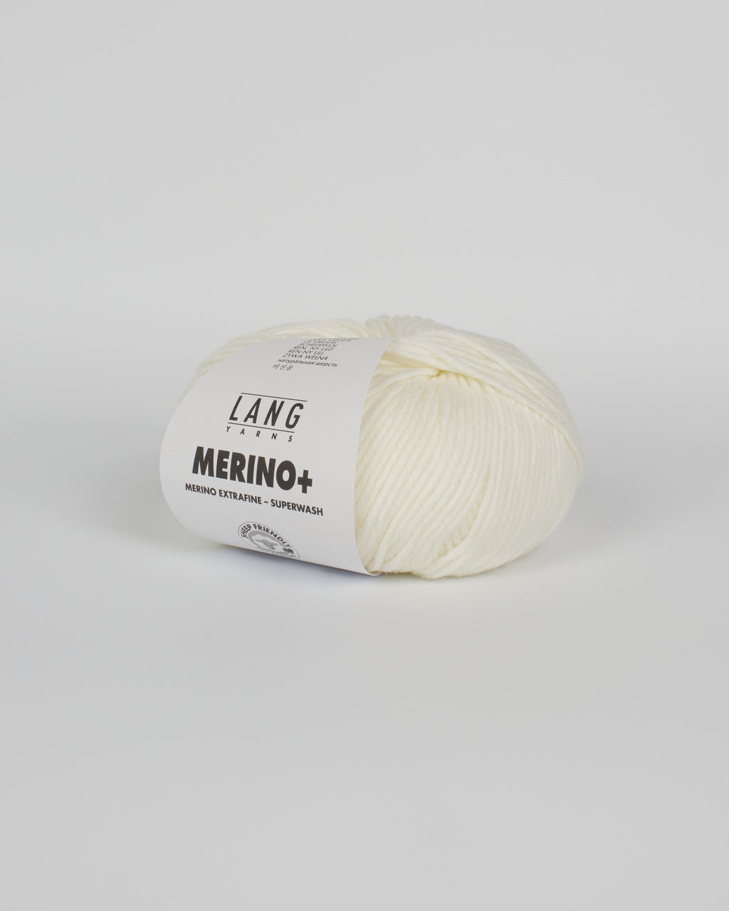 An off white ball of yarn on a white background