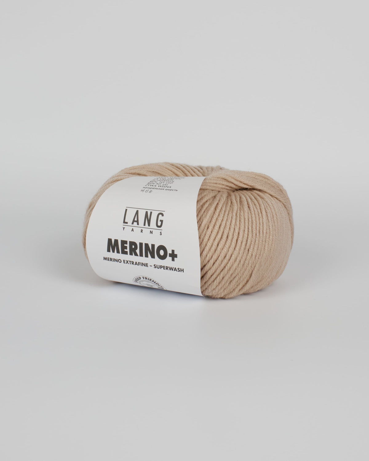 A beige ball of yarn on a white background