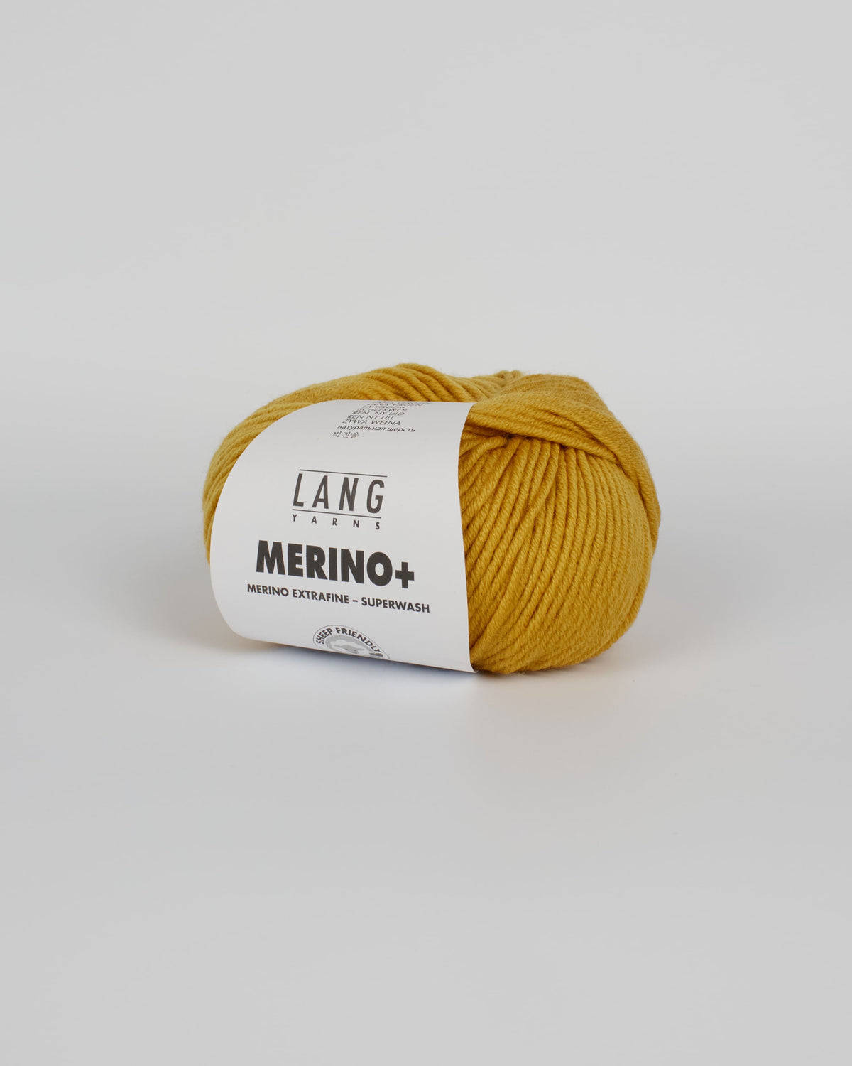 A mustard yellow ball of yarn on a white background