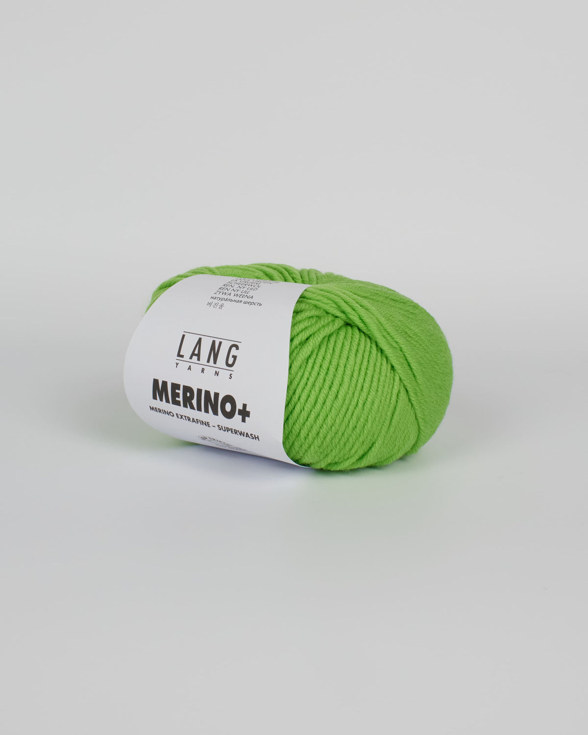 An apple green ball of yarn on a white background