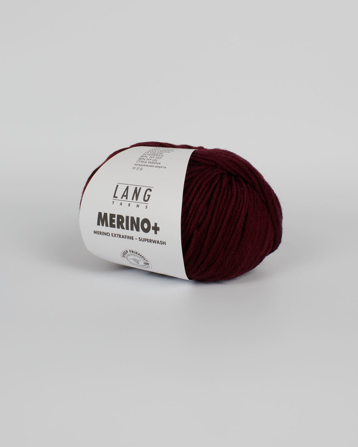A dark burgundy ball of yarn on a white background