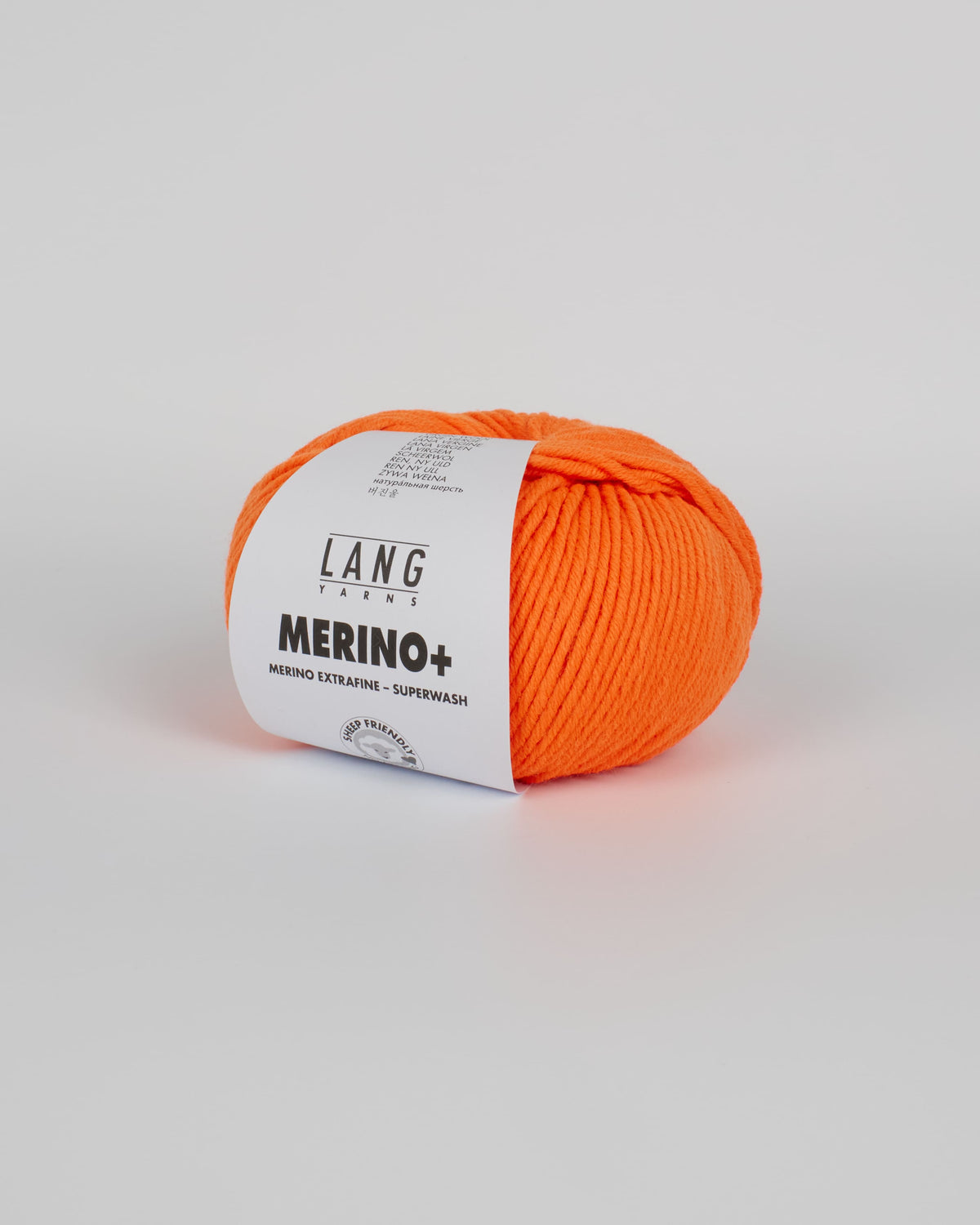 A bright orange ball of yarn on a white background