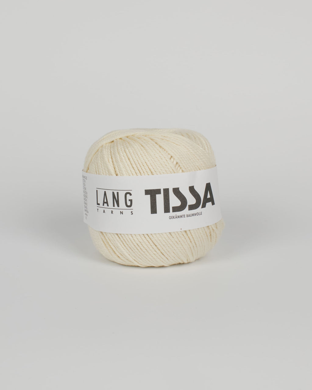 An off white ball of yarn on a white background