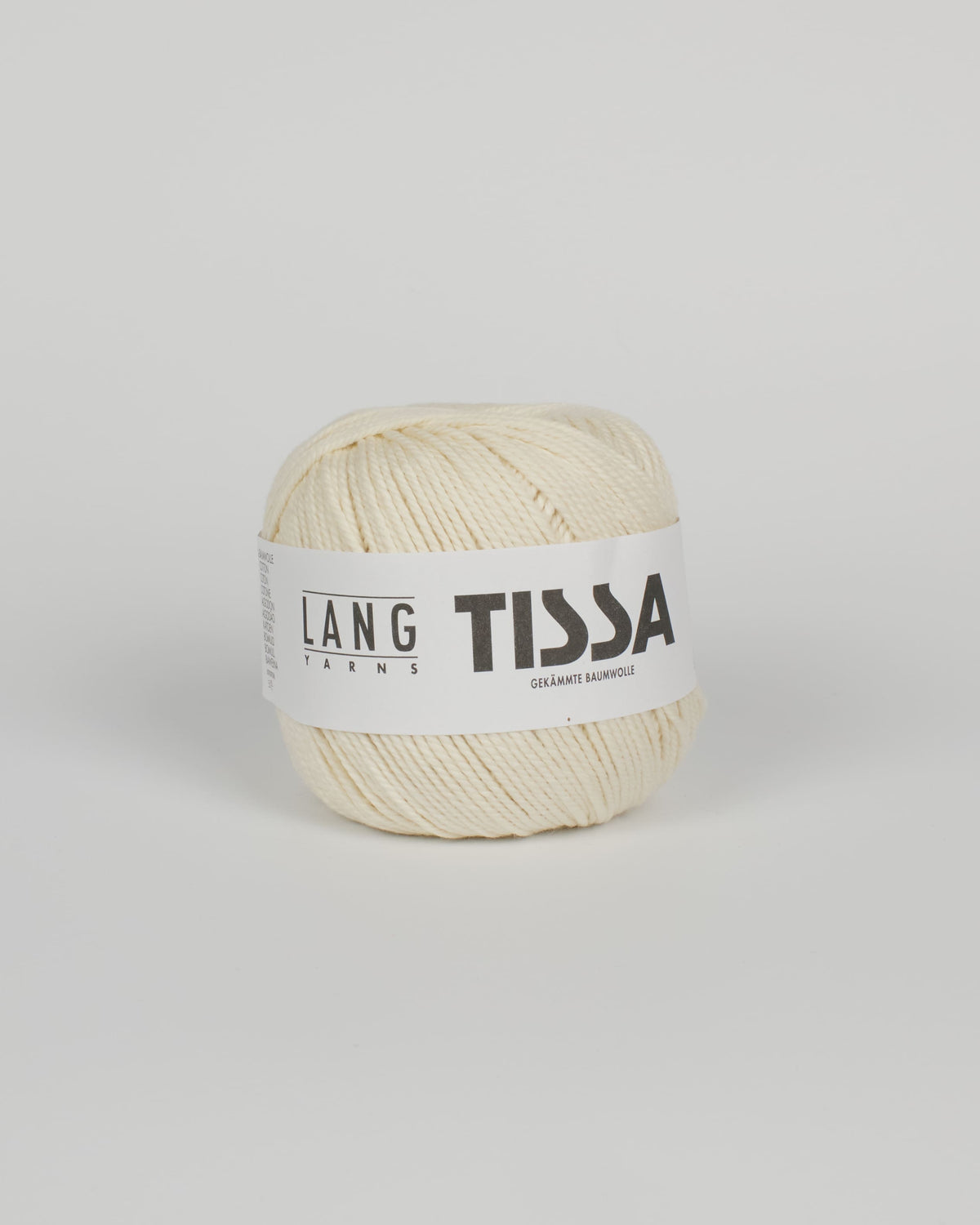 An off white ball of yarn on a white background