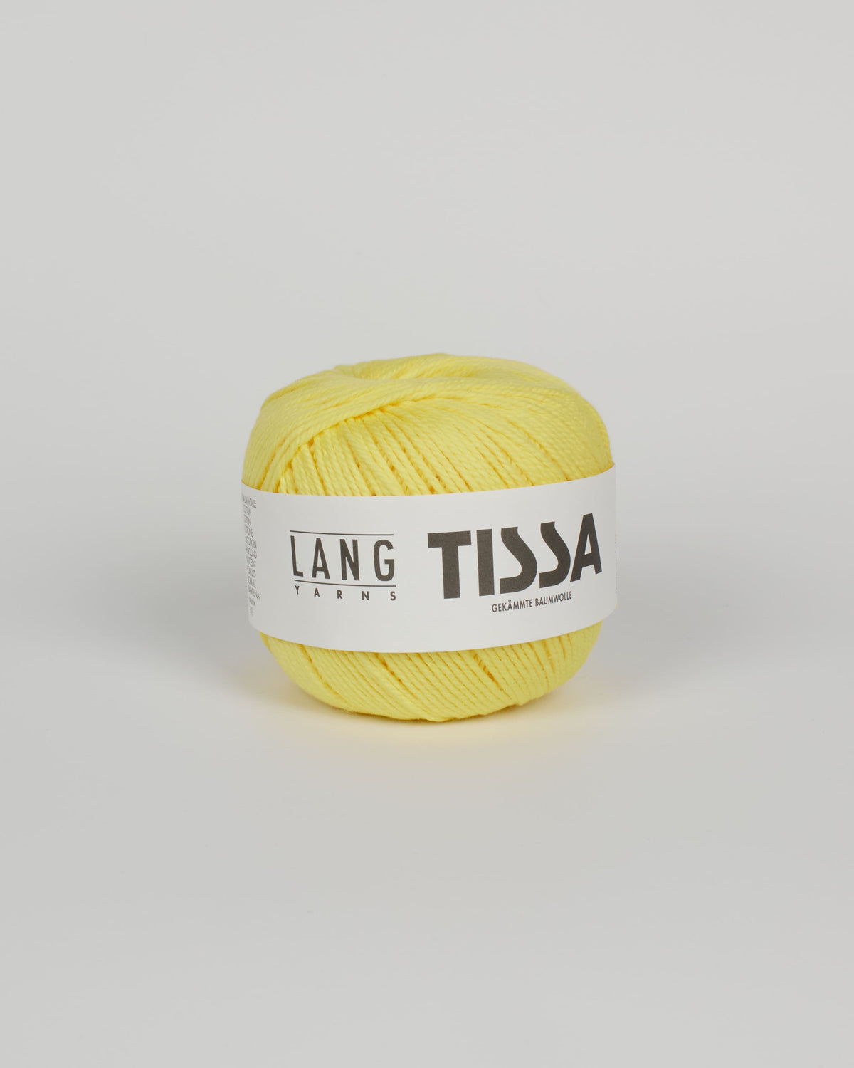 A lemon yellow ball of yarn on a white background