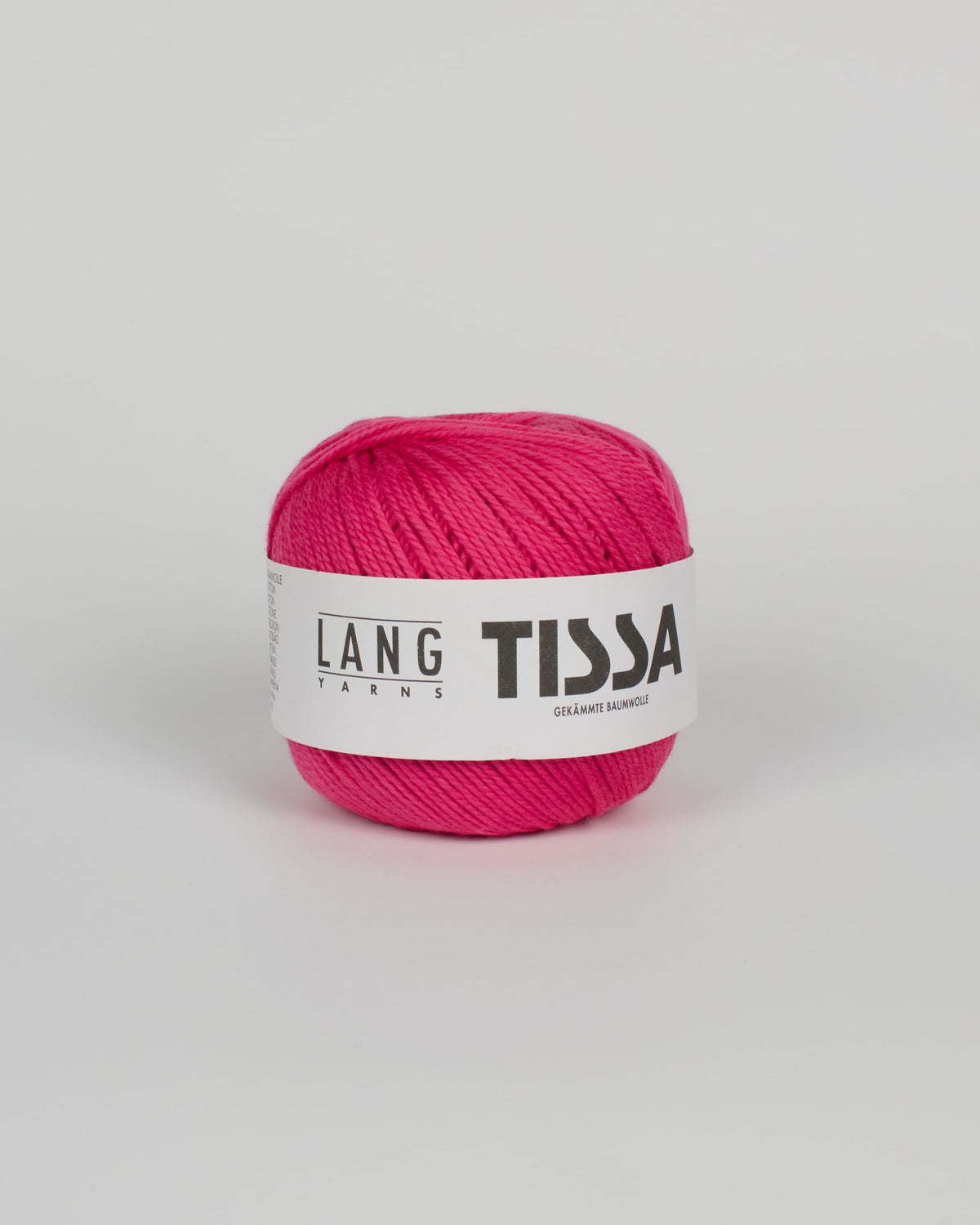 A bright pink ball of yarn on a white background