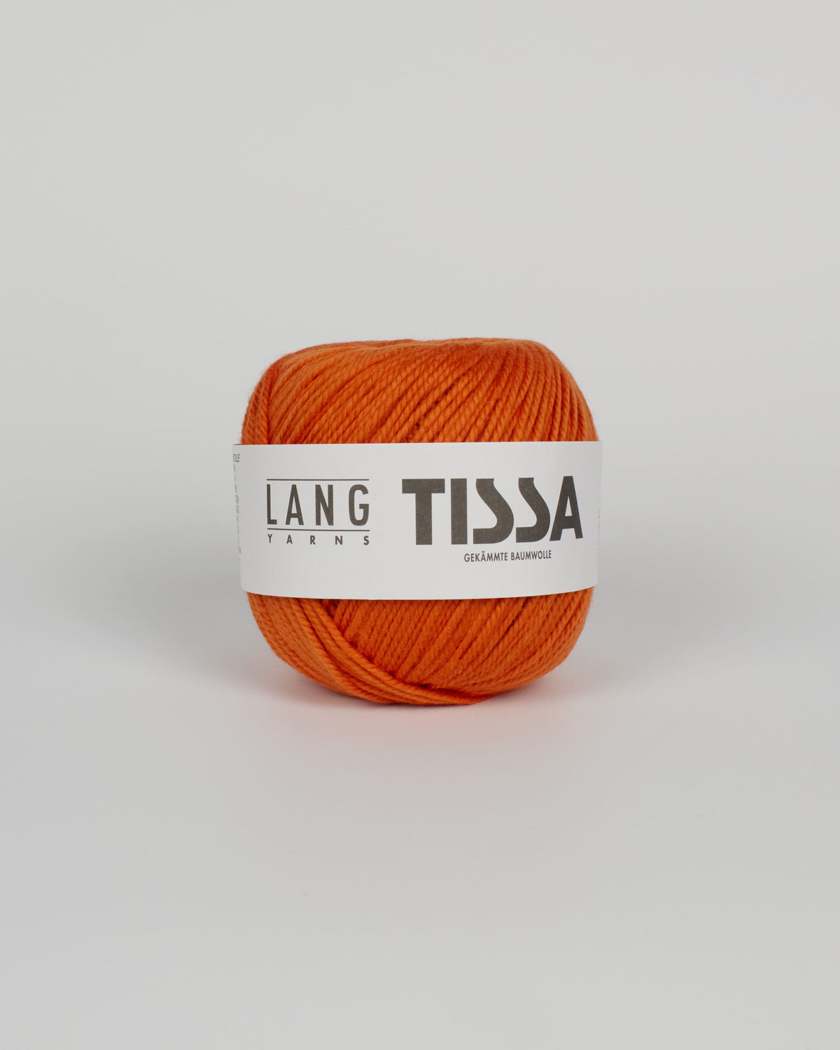 An orange ball of yarn on a white background