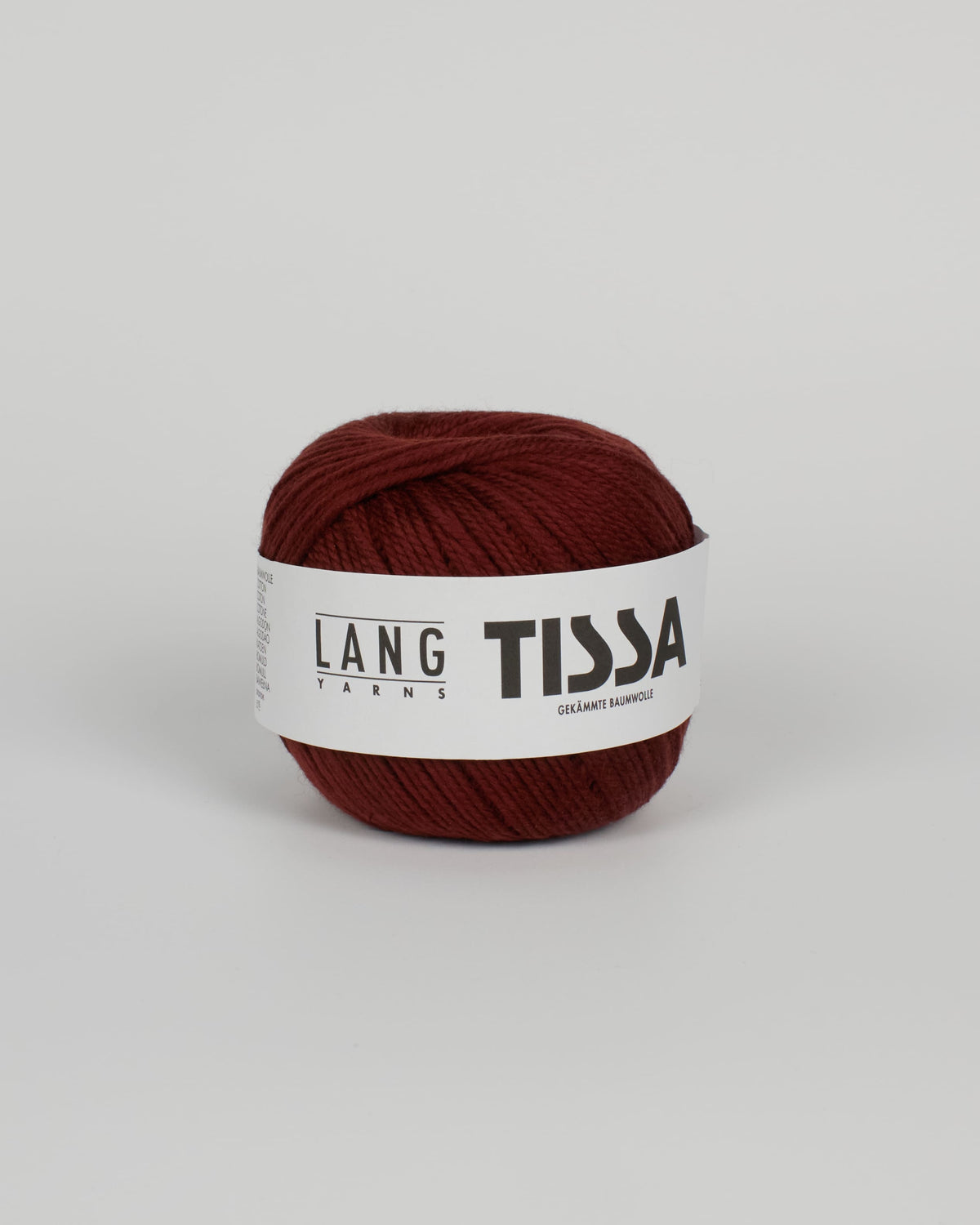 A chestnut brown ball of yarn on a white background